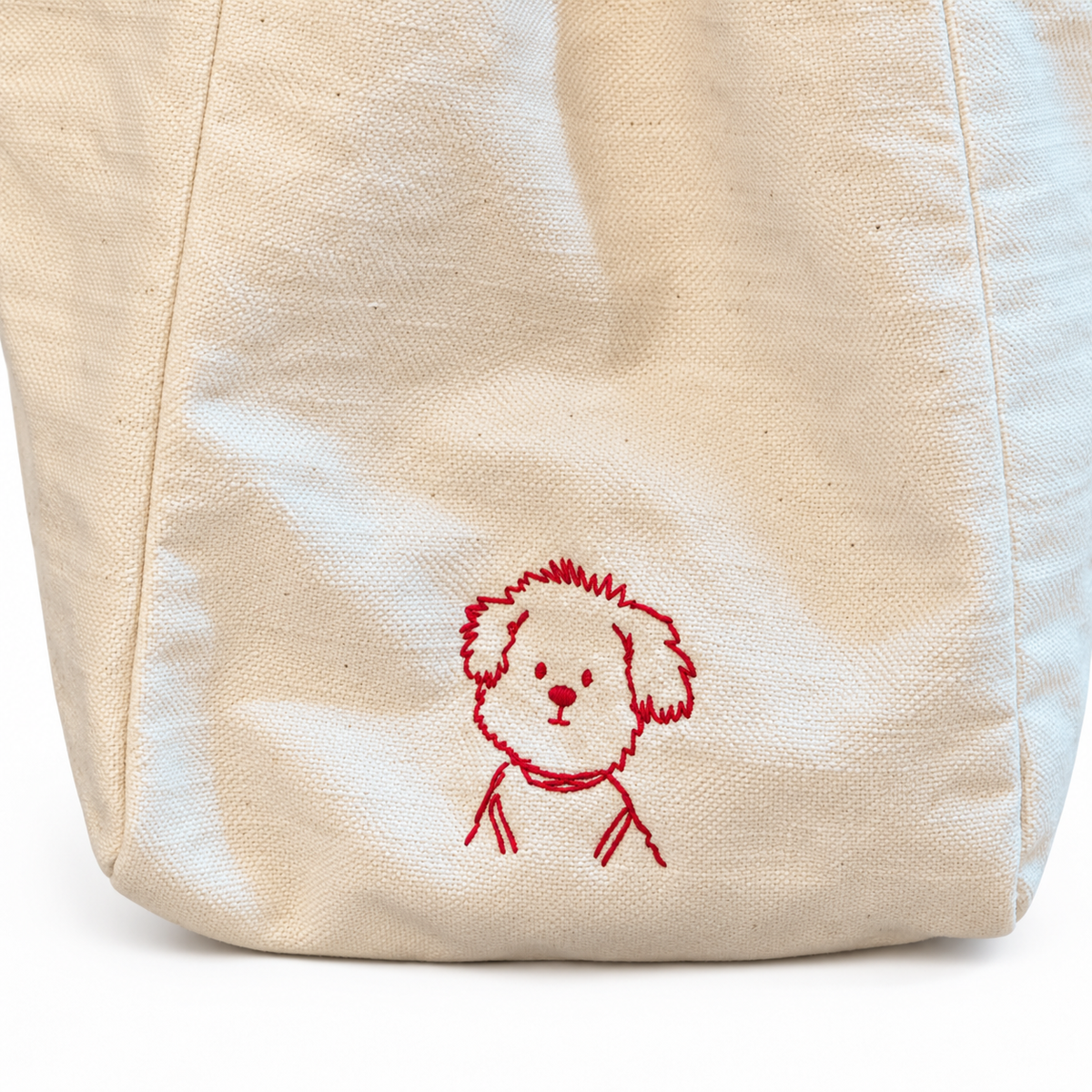 Close-up of the tote bag's dog embroidery