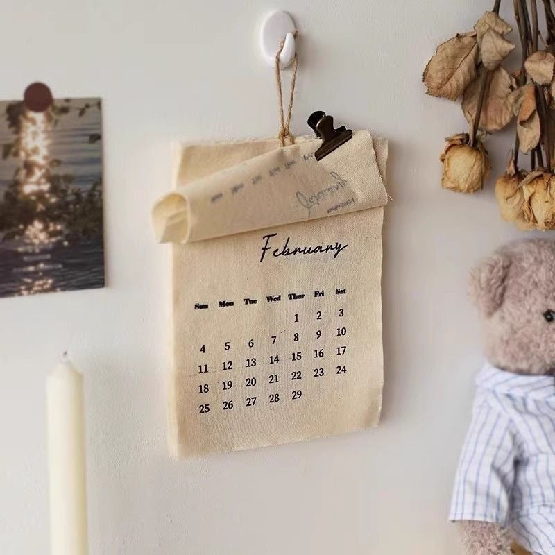 2027 fabric wall calendar with a rope hanger and magnetic clip