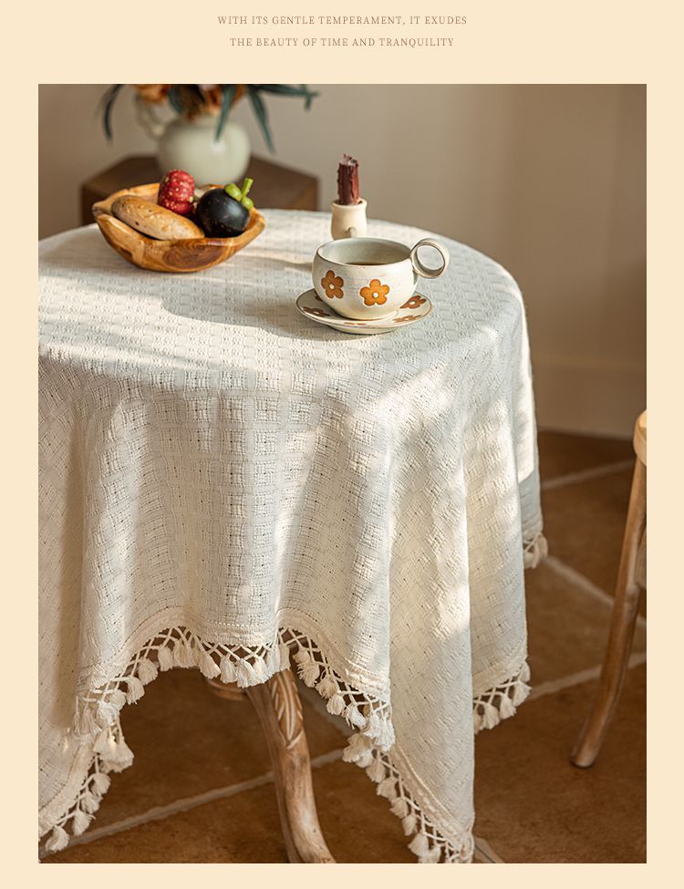 Beige tablecloth texture and tassel finish on a dining table