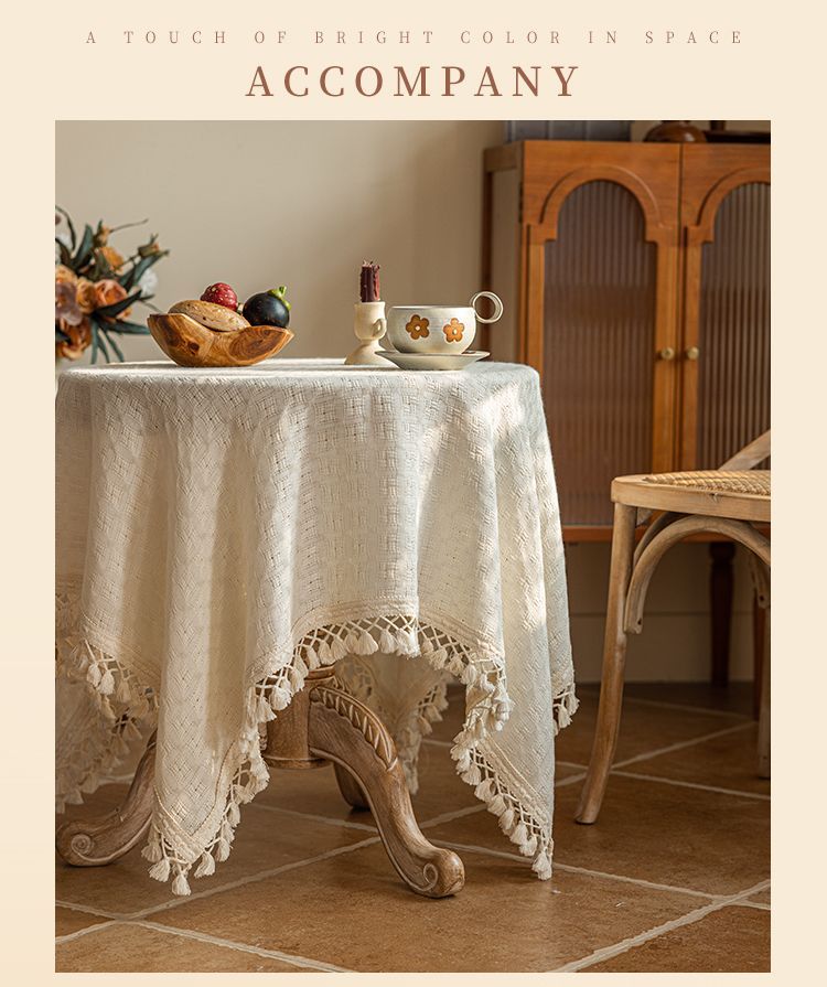 Beige tasseled tablecloth in a warm neutral interior
