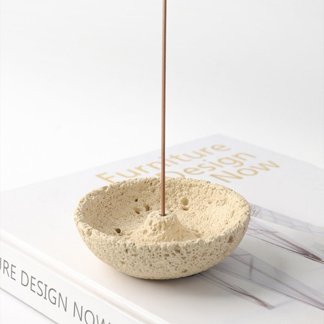 Cream textured cement incense holder with an incense stick