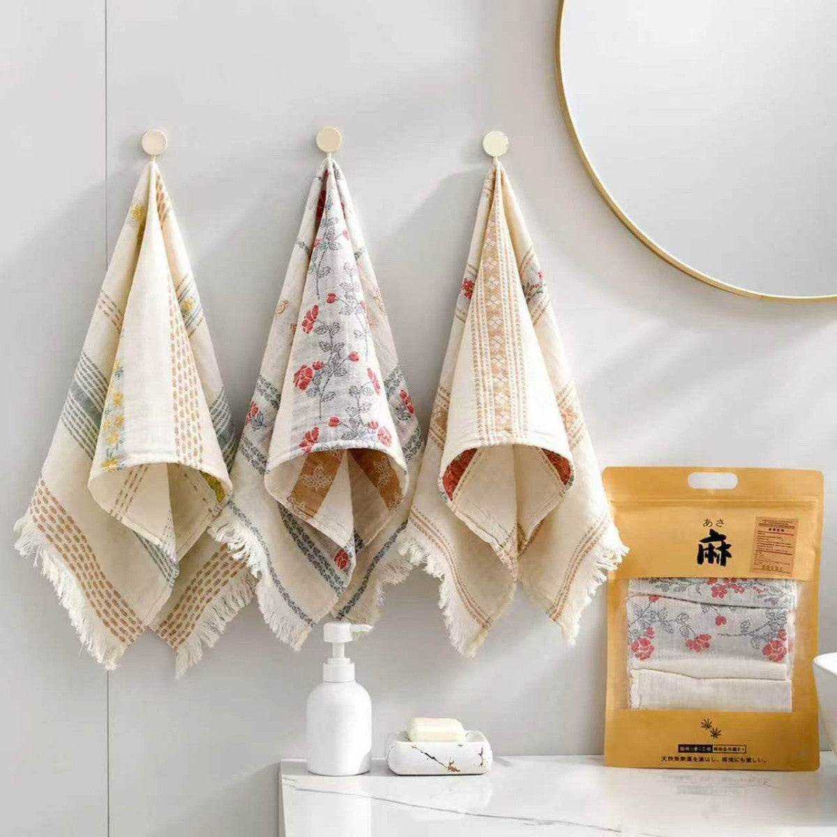 Three gauze hand towels displayed in a bathroom, with kraft packaging