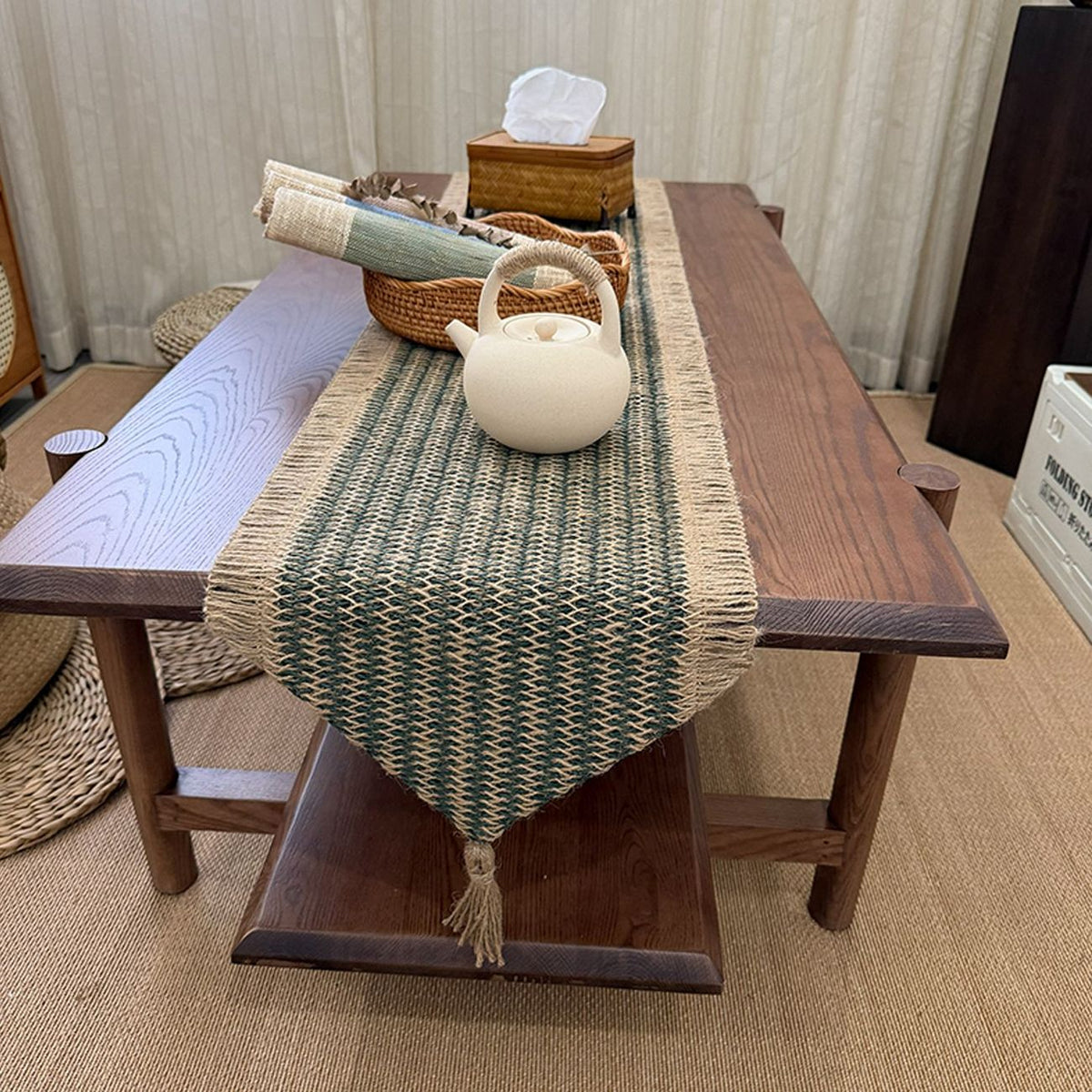 Overhead view of the dark green and natural woven table runner