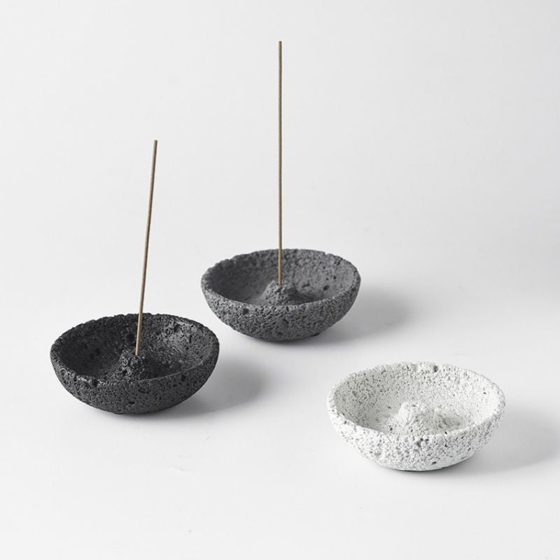 Three cement incense holders in light, grey and charcoal finishes